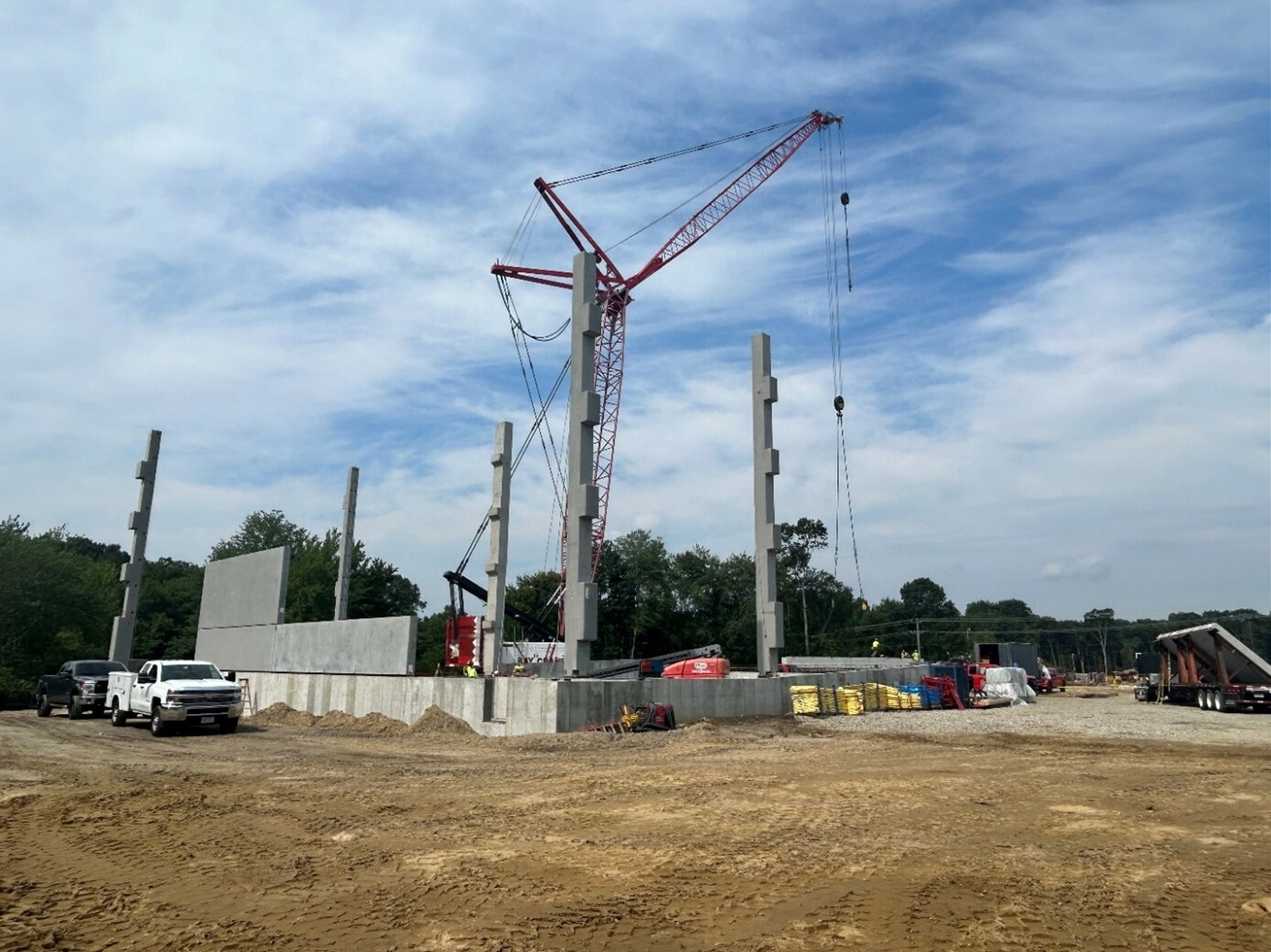 Ground view of a construction site with a crane at work.