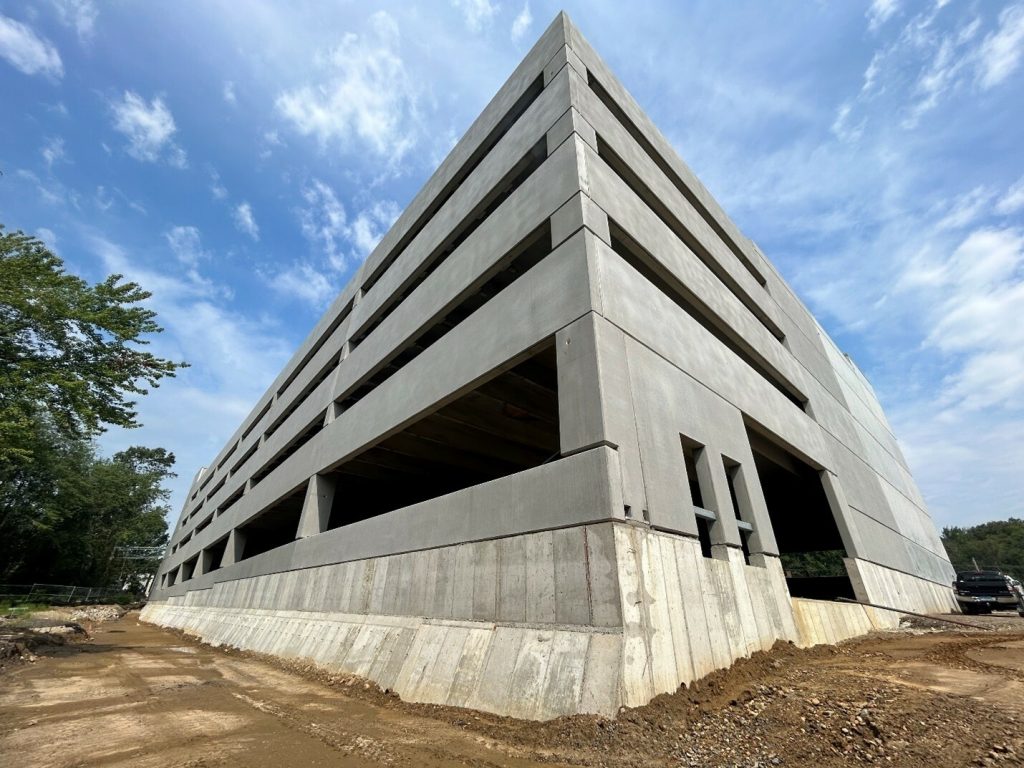 Ground corner view of a parking garage under construction.