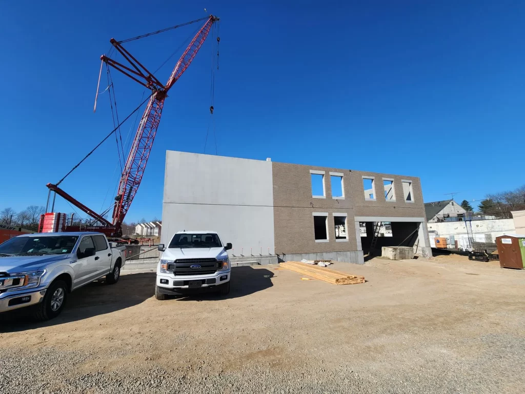 Erected precast panels with a crane in the background.
